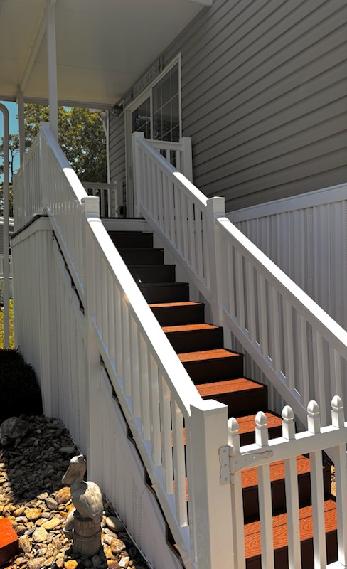 Deck with worn red-stained railings before remodel